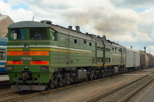 The cargo disel locomotive drives a heavy train