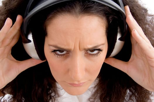 angry female listening music on headphone