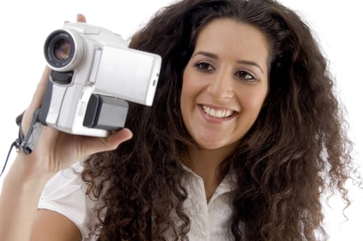 young photographer making video with handy cam on an isolated background