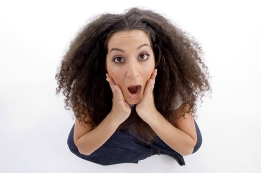 young woman surprised and looking upwards on an isolated white background