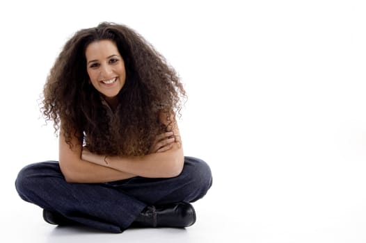 smiling woman sitting on the floor with white background