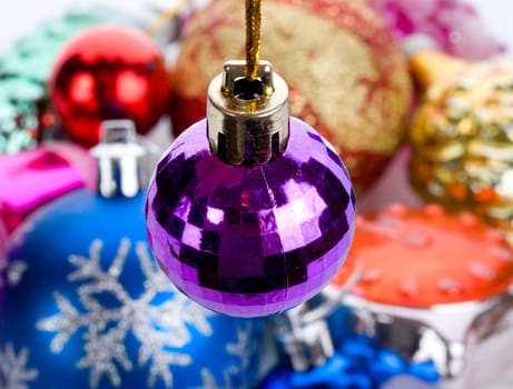 violet small fir ball, over toys background