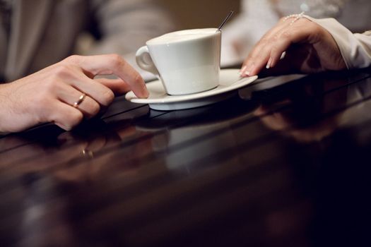 two hands and cup of coffee