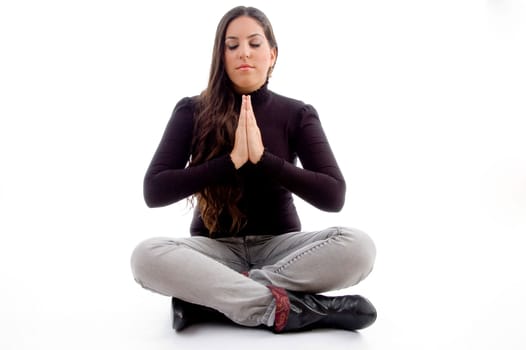 sitting praying young female against white background