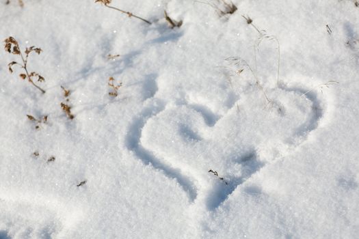 drawing of a heart on the snow