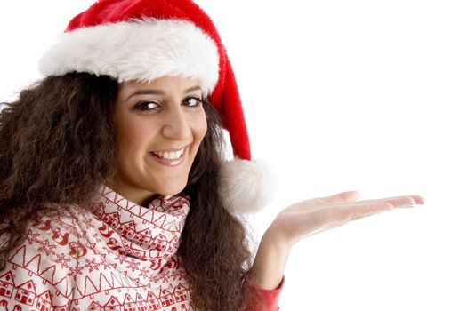 smiling young woman with christmas hat and open palm on an isolated white background