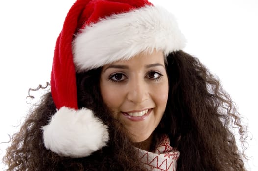 close view of young woman wearing christmas hat against white background
