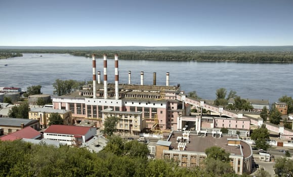 Building a power station in the city of Samara. On the bank of the Volga River. The building was built in 1930, the station was founded in 1904. Cityscape. Station building on the background of the Zhiguli Mountains