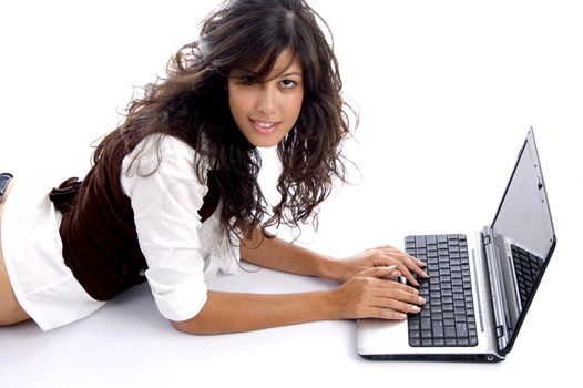 female operating laptop and looking at camera on an isolated white background
