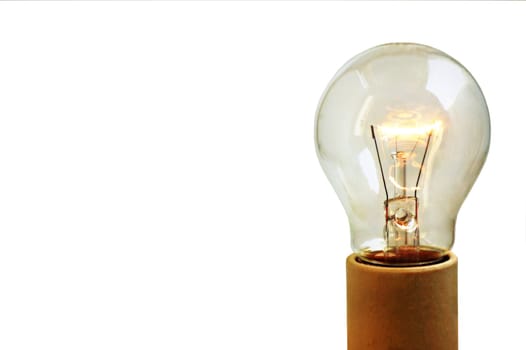 An old light bulb on, isolated on white background and on a socket