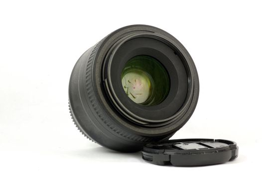 A 35mm prime dslr lens in detail isolated on white background view in angle
