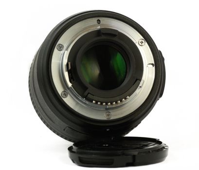 A 35mm prime dslr lens in detail isolated on white background rear view