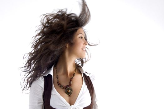 fashionable teen with her hair fluttering in air with white background