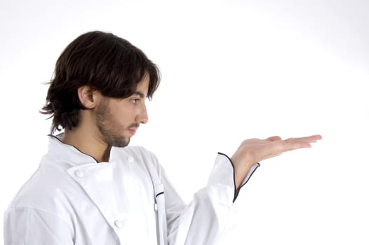 young chef looking his palm on an isolated background