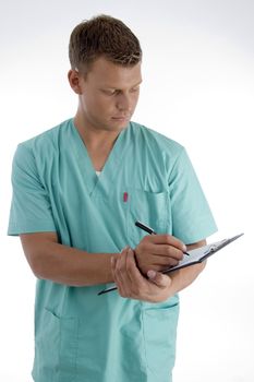 young male writing on writing pad against white background