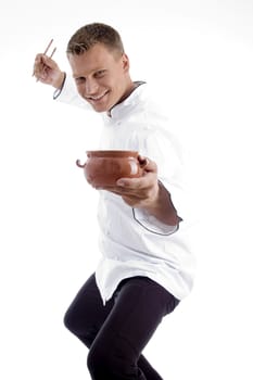 handsome chef posing with utensils on an isolated white background