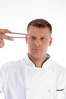 chef looking chopsticks against white background