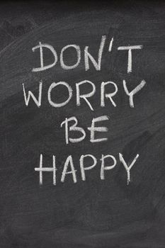 don't worry be happy phrase, a quote from Meher Baba, an Indian mystic and spiritual master (before it was used in a song lyrics), hadwritten with white chalk on  on blackboard