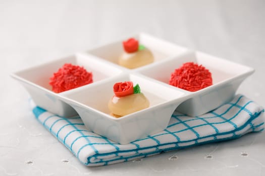 Small petit fours served in a white bowl