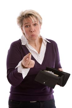 Mature woman pulling a face and holding up a eurocoin