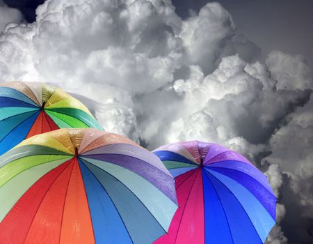 Rainbow umbrella against blue sky