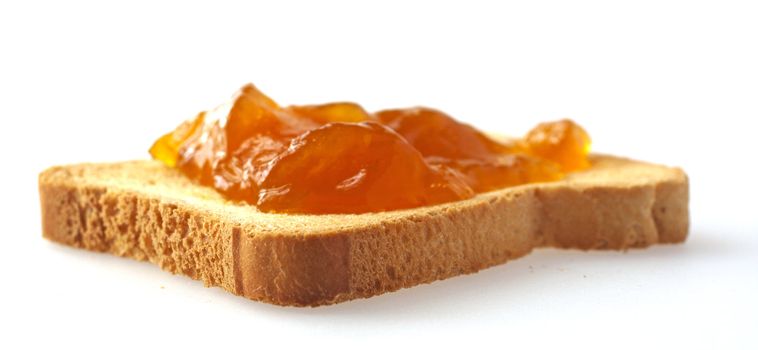 A toast with apricot jam over white background