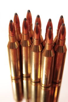 ammunition all in a bunch on a white background