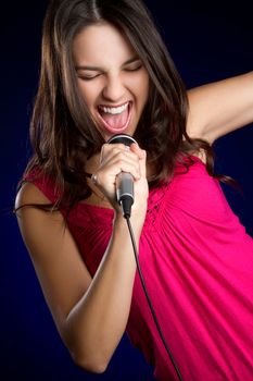 Pretty teen girl singing karaoke