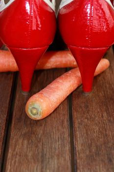 a pair of red high heels on top of carrots depicting carrots are cool