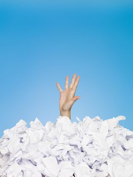 Human hand buried in papers