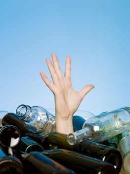 Human buried in a stack of glass bottles