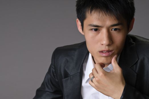 Asian business man closeup portrait, young, handsome and confident expression.