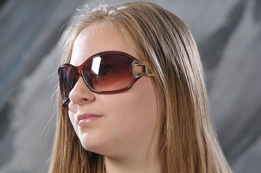 portrait of long-haired girl is in sun glasses