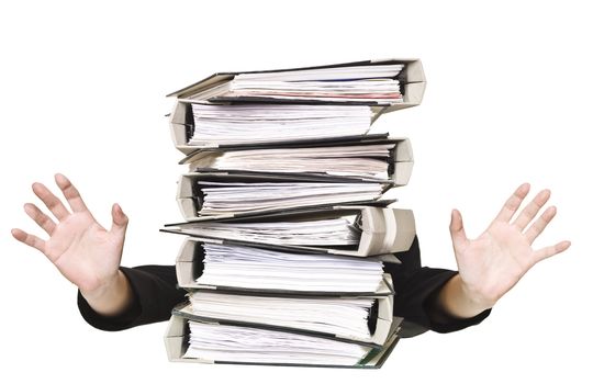 Human behind a stack of Ring Binders isolated on white background