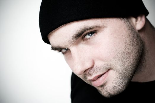 Portrait of young man wearing beanie - selective focus on the model's eyes.