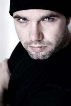 Portrait of young man wearing beanie - selective focus on the model's right eye.