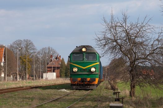 Freight train hauled by the diesel locomotive waiting at the station
