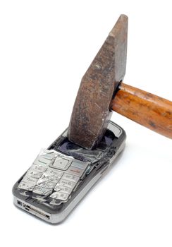 Hammer smashing cellular phone isolated on the white background