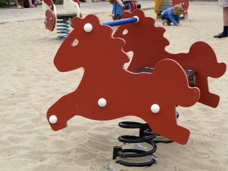 Rocking horse in sand outdoors