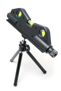 Laser level tool on a tiny tripod isolated over white background
