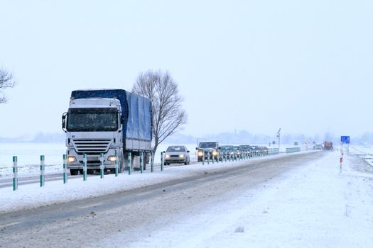 Big rig passing through the snowy countryside