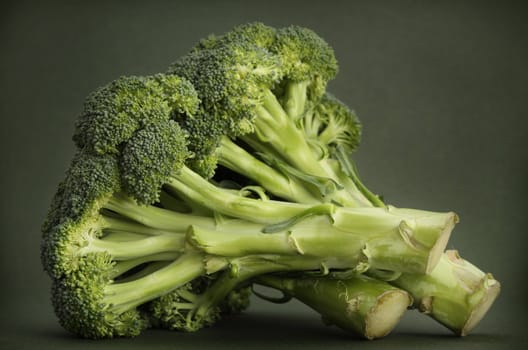 fresh raw broccoli, green background