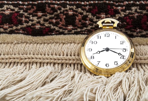 Elegant Gold pocket watch over a carpet