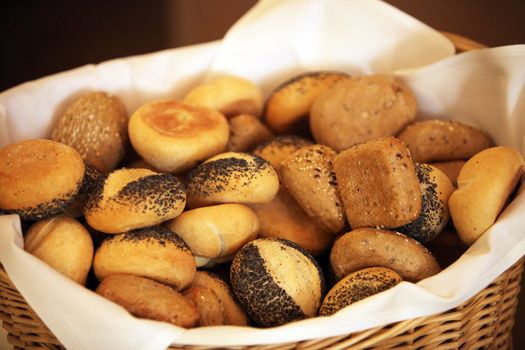 many different bread rolls in a rustic bread basket