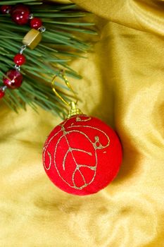 Christmas ornaments of red ball in silky golden fabric with tree