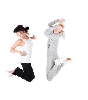 Shoot of two jumping fitness instructors isolated on white