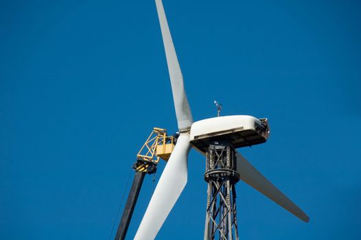 Shot of man who repairs broken windmill