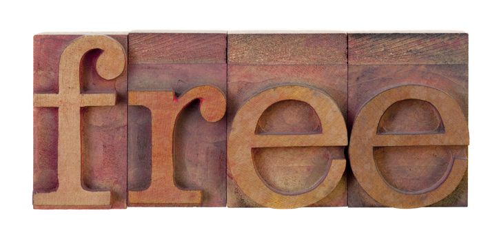 the word free in vintage wooden letterpress type blocks, stained by red ink, isolated on white
