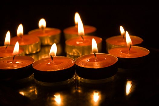 lit candles on black background