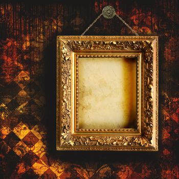 Grungy tattered wallpaper with empty picture frame